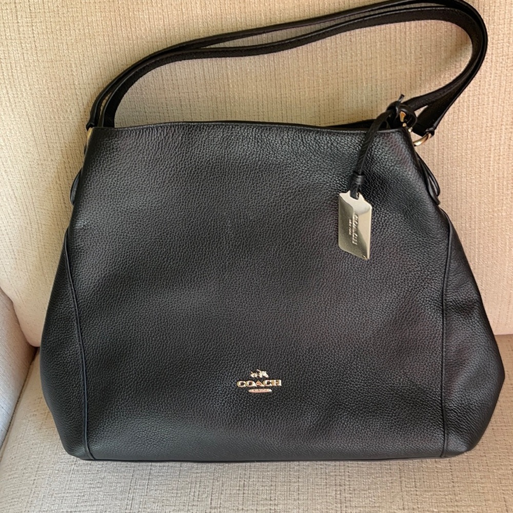 Black coach purse with gold accents.
